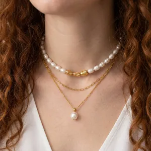 Layered freshwater pearl necklace set with 18k gold plated chain and elegant pendant detail.