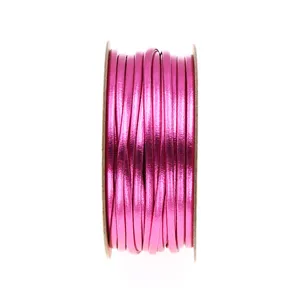 Close-up of metallic pink PU leather cord rolled on spool for DIY jewelry crafting accessories.