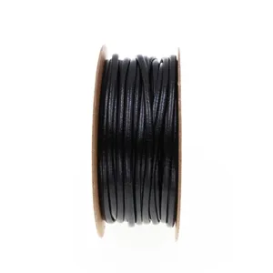 Detailed view of the 2mm black PU leather cord wound on a spool for DIY jewelry making.
