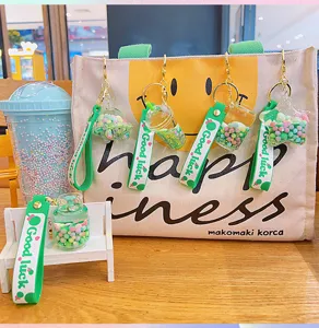 Cute green quicksand oil-filled floating keychain pendant backpack bag charm accessory.