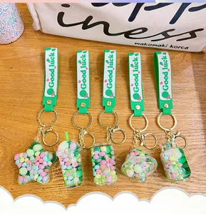 Cute green quicksand oil floating keychain pendant set, creative bag charm ornament for kids.