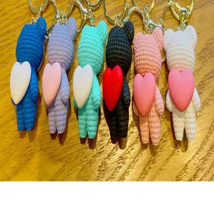 Cute crochet bear keychain with heart charm, handmade style plush bag pendant accessory.