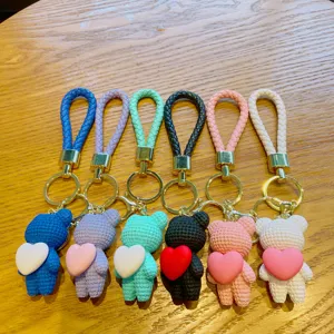 Cute woven bear keychain with heart pendant, colorful PU leather braided strap bag charm for keys.