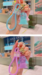 Cute cartoon rabbit keychain with silicone strap and bell, perfect bag charm and gift.