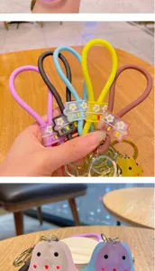 Colorful silicone wristlet keychain with cute cartoon doll pendant for car keys and bags.