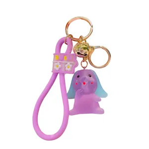 Cute purple animal cartoon keychain with silicone strap and bell, stylish bag charm pendant.