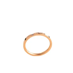 Minimalist rose gold stainless steel ring for women with a single dainty diamond accent.