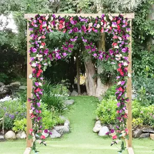 Artificial rose vine garland for wedding decoration, plastic floral arch setup for party.