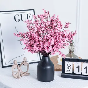 Details of pink artificial flower bouquet with black vase for home decor and table centerpiece.