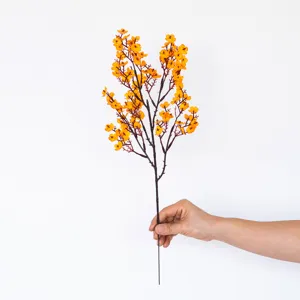Artificial yellow flower branch detail view, perfect for home decor and floral arrangements.