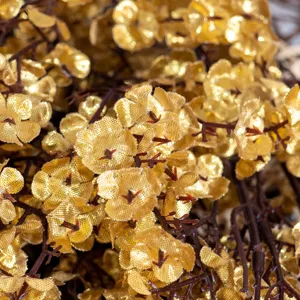 Golden artificial baby's breath flower close-up, sparkling floral decor for home wedding.
