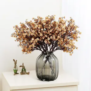 Artificial gypsophila flowers bouquet with ribbed glass vase for home decor.