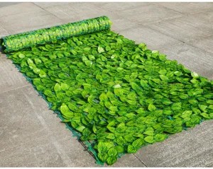 Detailed close-up of artificial green leaf fence mesh showcasing realistic foliage texture.