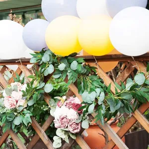 Artificial eucalyptus garland with willow leaves and fake roses for wedding decor.
