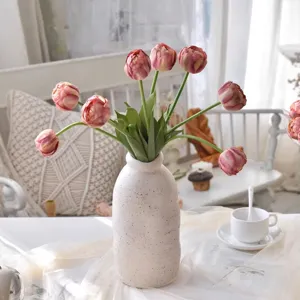 Artificial tulips bouquet in speckled ceramic vase for home living room decor photography.