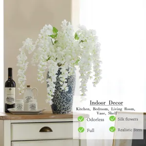 Flores artificiales blancas de glicinia en florero de cerámica azul para decoración.