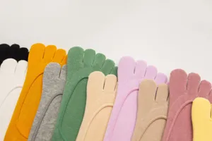 Close-up detail of colorful cotton five-toe socks neatly arranged, soft fabric texture.