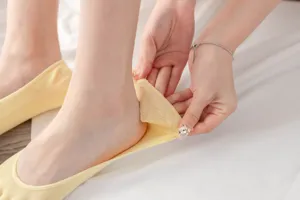 Close-up detail showing the soft fabric and elastic stretch of these cute yellow five-finger socks.