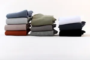 Close-up detail view of breathable mesh men's short socks stacked neatly in multiple colors.