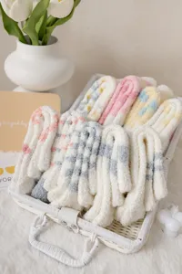 Close up shot of fluffy coral fleece socks in basket, cozy home wear fuzzy detail.