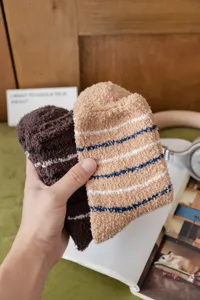 Detailed shot of soft thickened coral fleece men socks with cozy striped pattern for indoor floor.