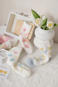 Fluffy coral fleece warm mid-calf socks for women, cozy home floor socks with cute colorful floral patterns.
