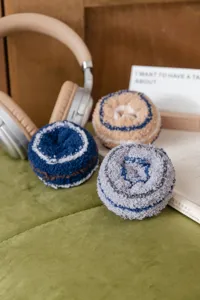 Detailed view of thick coral fleece men sleep socks rolled in donut shape, cozy floor socks.