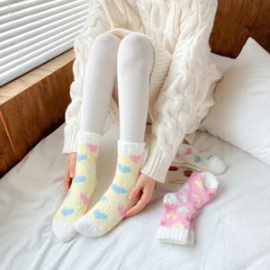 Cozy fuzzy coral fleece women mid-tube socks with cute colorful heart patterns for home wear.