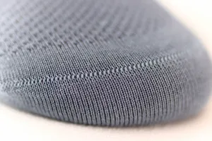 Close-up detail of grey breathable knit cotton men socks mesh texture fabric showcase