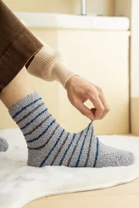 Thickened coral fleece men sleep socks detail showing soft fuzzy fabric and stretch fit.