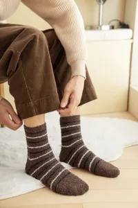 Detailed shot of thick brown coral fleece socks with cozy striped pattern for indoor wear.