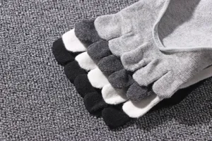 Detail shot of men's five-toe socks showing neat toe stitching and breathable knit fabric texture.