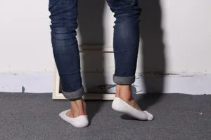 Detailed view of mens white five toe low cut socks showing separation.