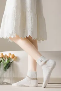 Close up of women white mesh short socks with cute bear embroidery, breathable and casual style.