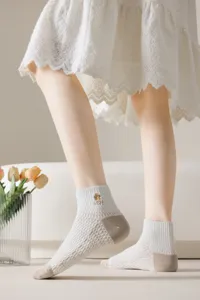 Detailed view of women's breathable mesh short socks featuring delicate ankle embroidery for summer.
