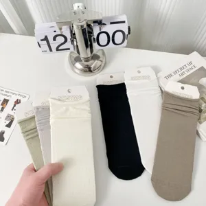 Women solid color thin breathable mid-tube socks with rolled edge design for summer wear.