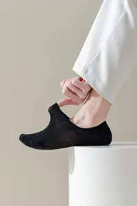 Detailed view of breathable black mesh men's boat socks showing elastic stretch and fabric.