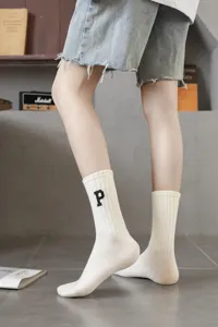 Women white mid-tube socks with stylish letter embroidery, perfect for casual daily wear.