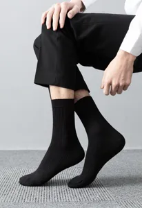 Close-up detail of men's black ribbed mid-tube socks worn by model for daily wear comfort.
