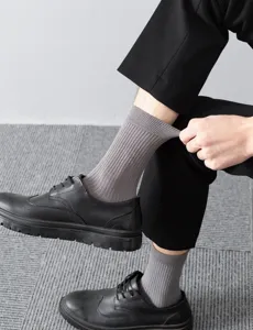 Men's grey ribbed crew socks detail shot, soft cotton knit daily wear casual footwear.