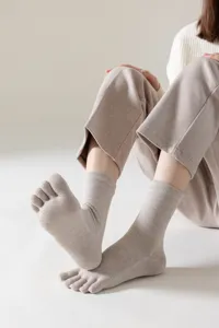 Close-up detail of cozy five-toe socks, soft knit fabric with separate toe design for comfort.