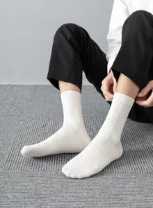Men's white ribbed mid-tube socks detail view, showing breathable cotton texture and fit.
