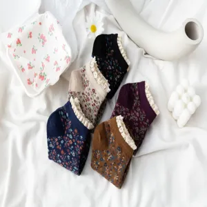 Detail shot of floral lace cotton short socks, retro style design with delicate trim.