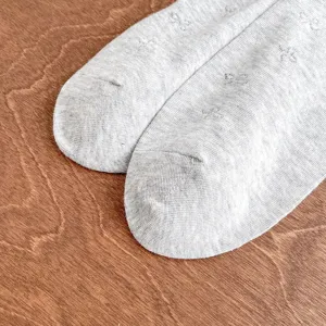Grey knit women socks featuring delicate woven bow patterns, perfect for daily wear.