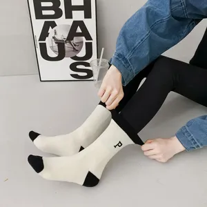 Thickened mid-tube winter fleece socks with contrasting color toe and letter print design.