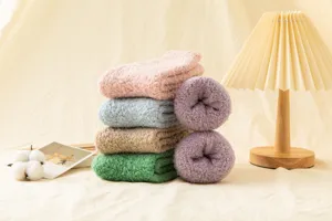 Cozy solid color coral fleece winter socks for women, soft mid-tube fuzzy thermal socks detail.