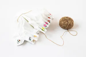 Detailed view of white cotton women ankle socks featuring cute colorful fruit embroidery.