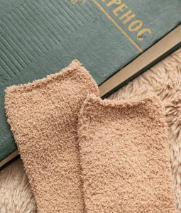 Plush fuzzy coral fleece sock detail view, thick warm winter sleep home floor sock fabric.