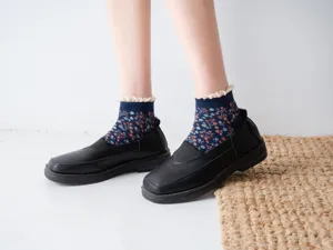 Detail shot of Japanese retro floral lace boat socks for women, paired with black flat shoes.