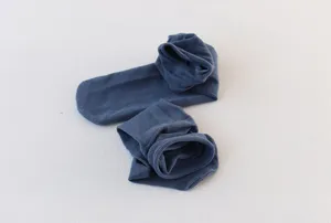 Solid color women pile socks detail shot showing soft fabric and loose roll edge design.